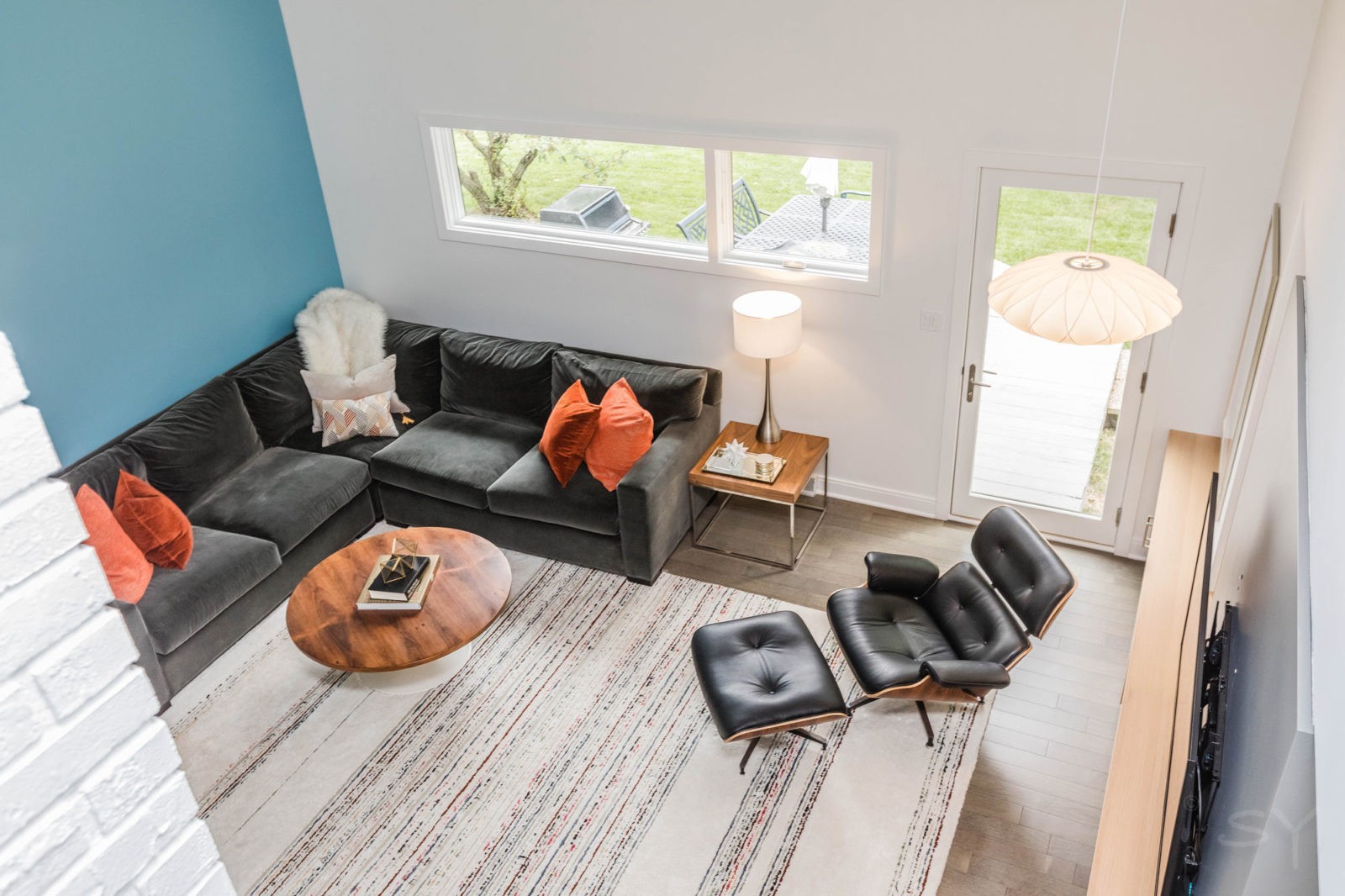 LivCo living room renovation overhead view mid century modern style décor white and blue walls