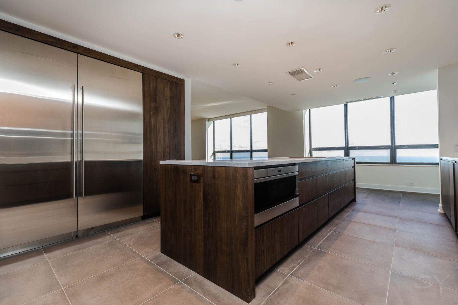 Kitchen with island, dark wood cabinets, and silver appliances