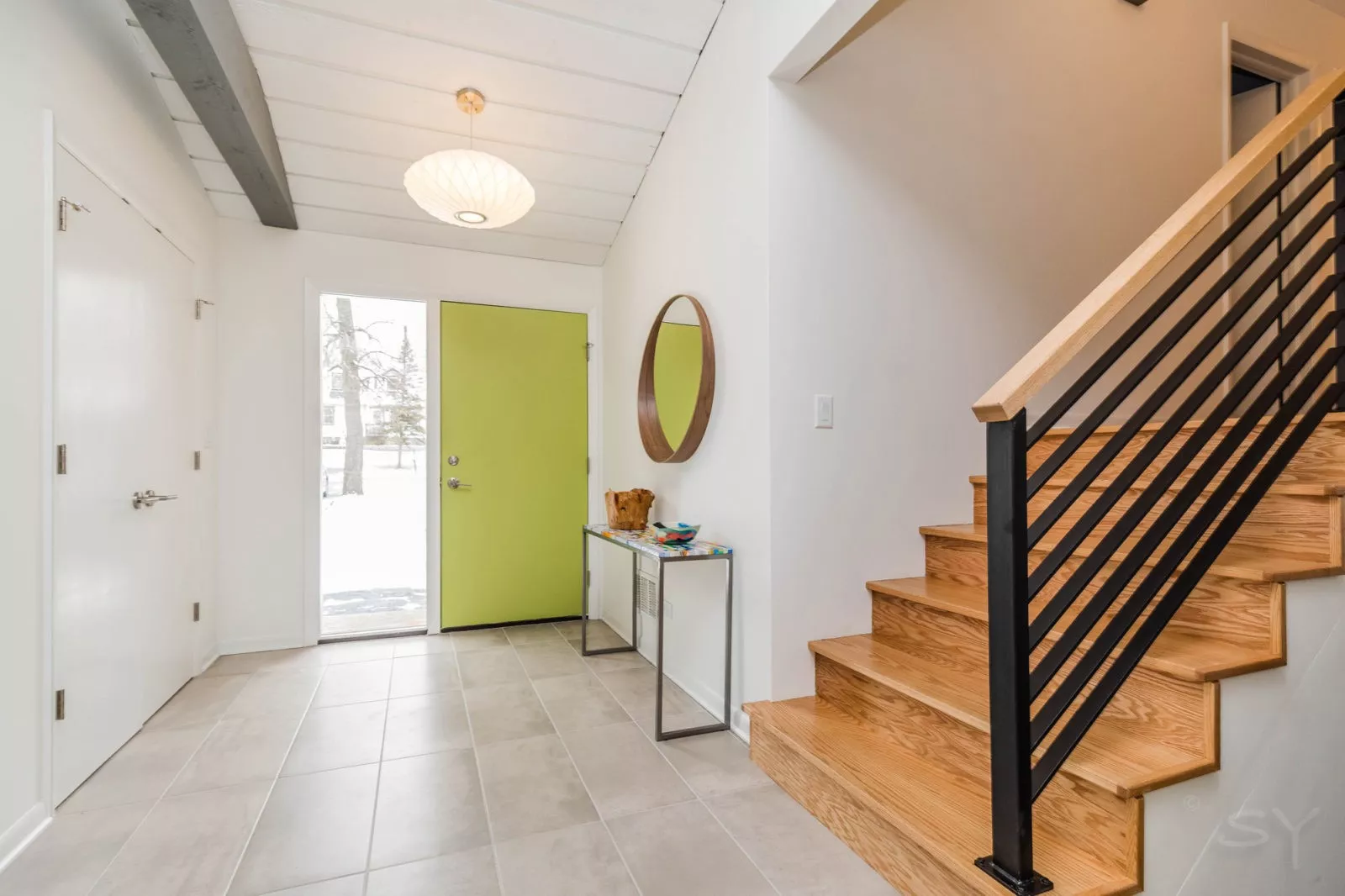 livco foyer remodel lime green door light tile flooring hardwood steps open railing wood beams