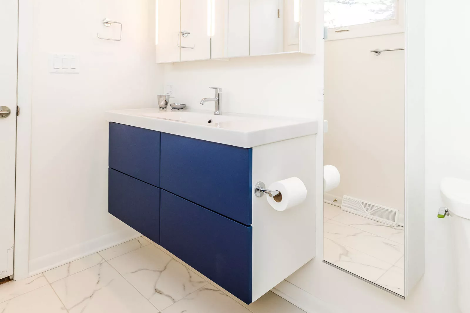 livco bathroom renovation floating sink beside mounted mirror granite flooring white cabinets