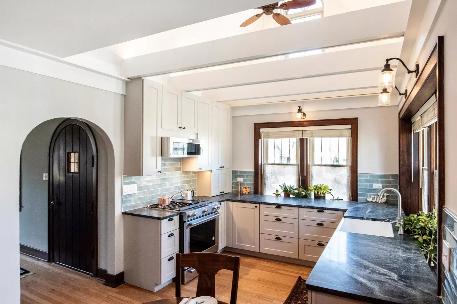 kitchen renovation traditional home black quarts countertops white exposed ceiling beams
