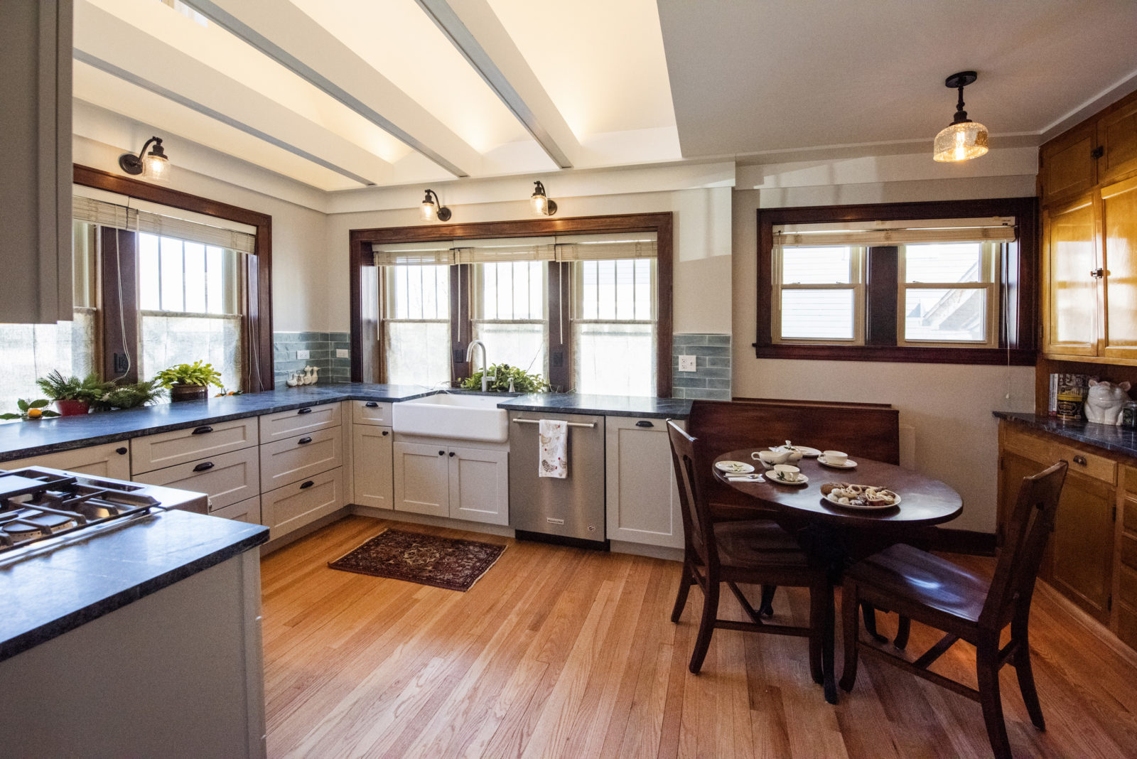 u shaped kitchen remodel white exposed ceiling beams hardwood floors small dining table