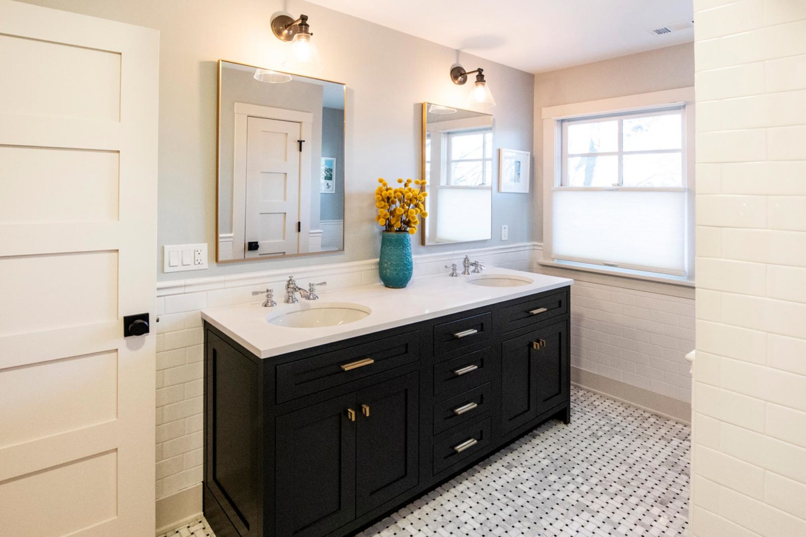 LivCo bathroom remodel black vanity white patterned flooring double sink and mirror