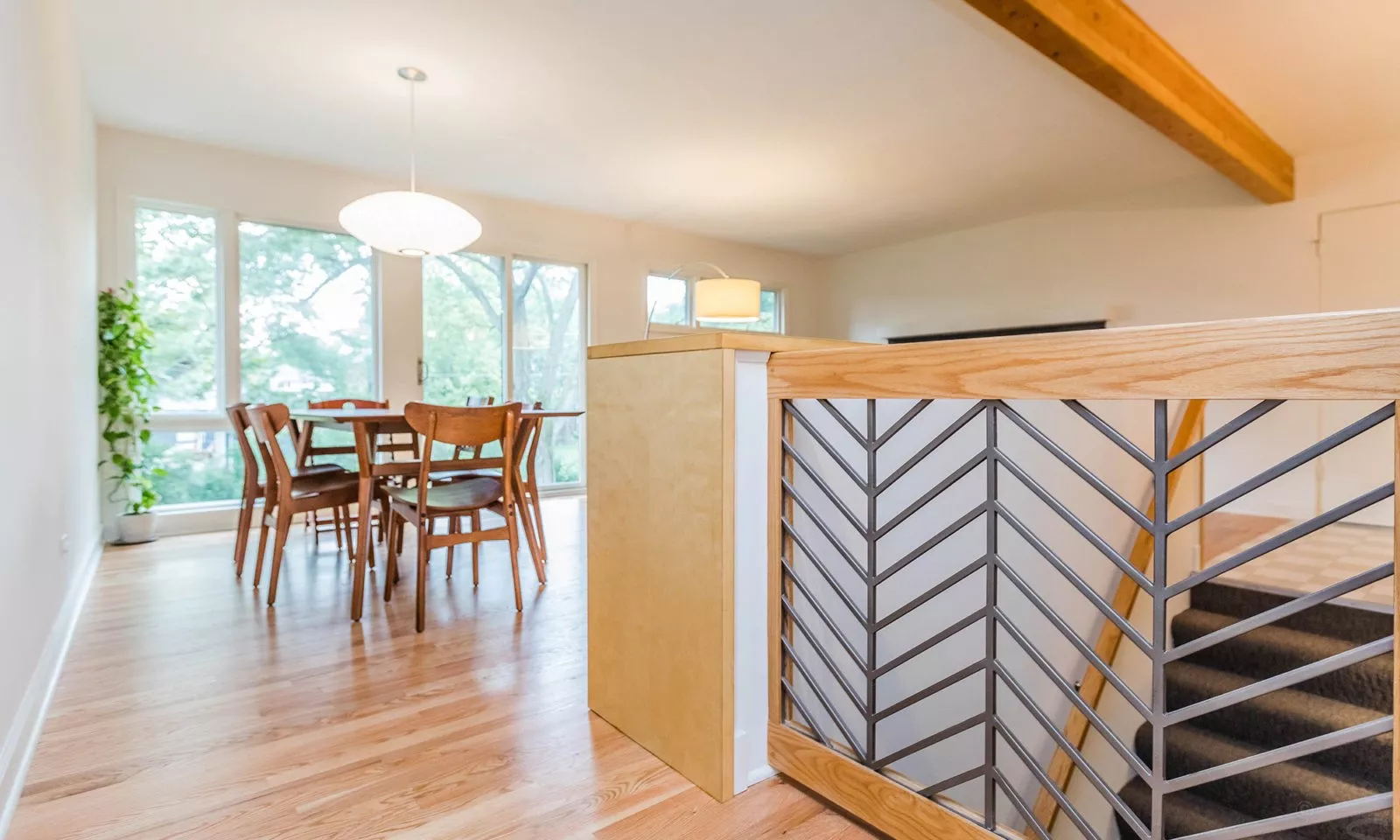 mid century modern ranch renovation and remodel view of custom railing at basement stair opening