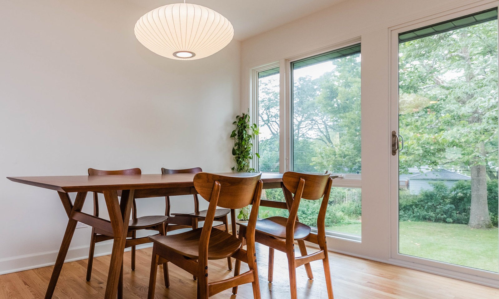 mid century modern ranch renovation and remodel view of dining room with floor to ceiling windows