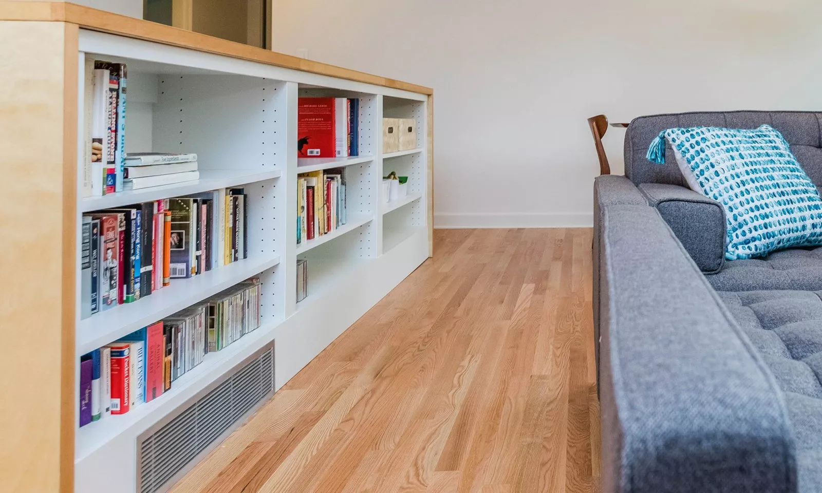 mid century modern ranch renovation and remodel view of open shelving room divider from family room