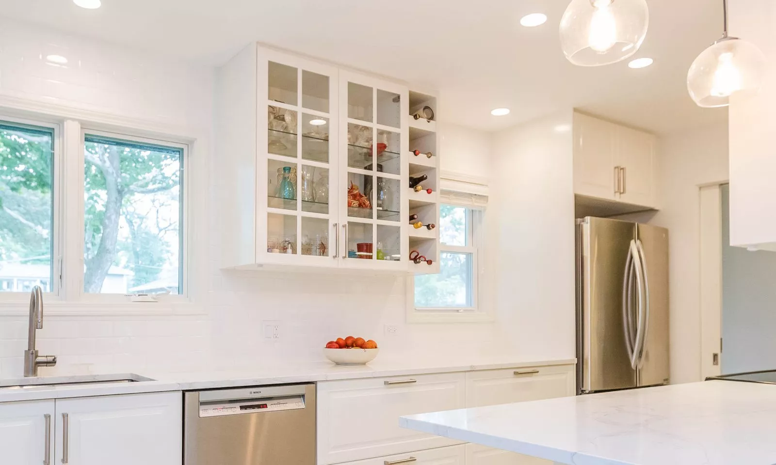 mid century modern ranch renovation and remodel view of white kitchen with open wine storage