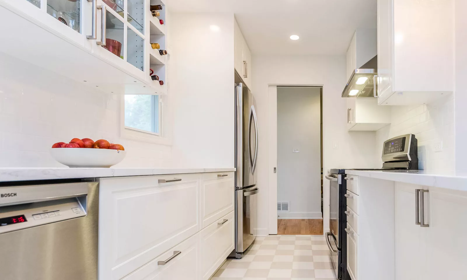 mid century modern ranch renovation and remodel view of white kithcen with stainless steel appliances