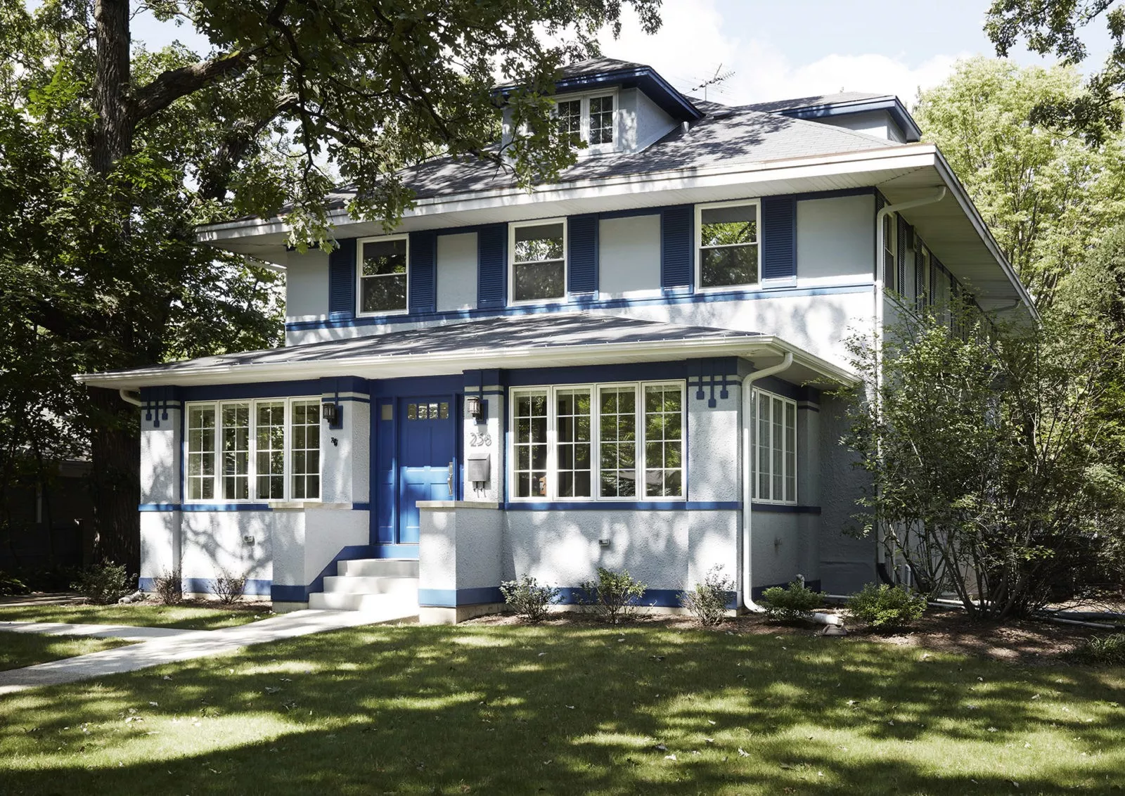 LivCo exterior home remodeling and renovation grey and blue home with blue shutters