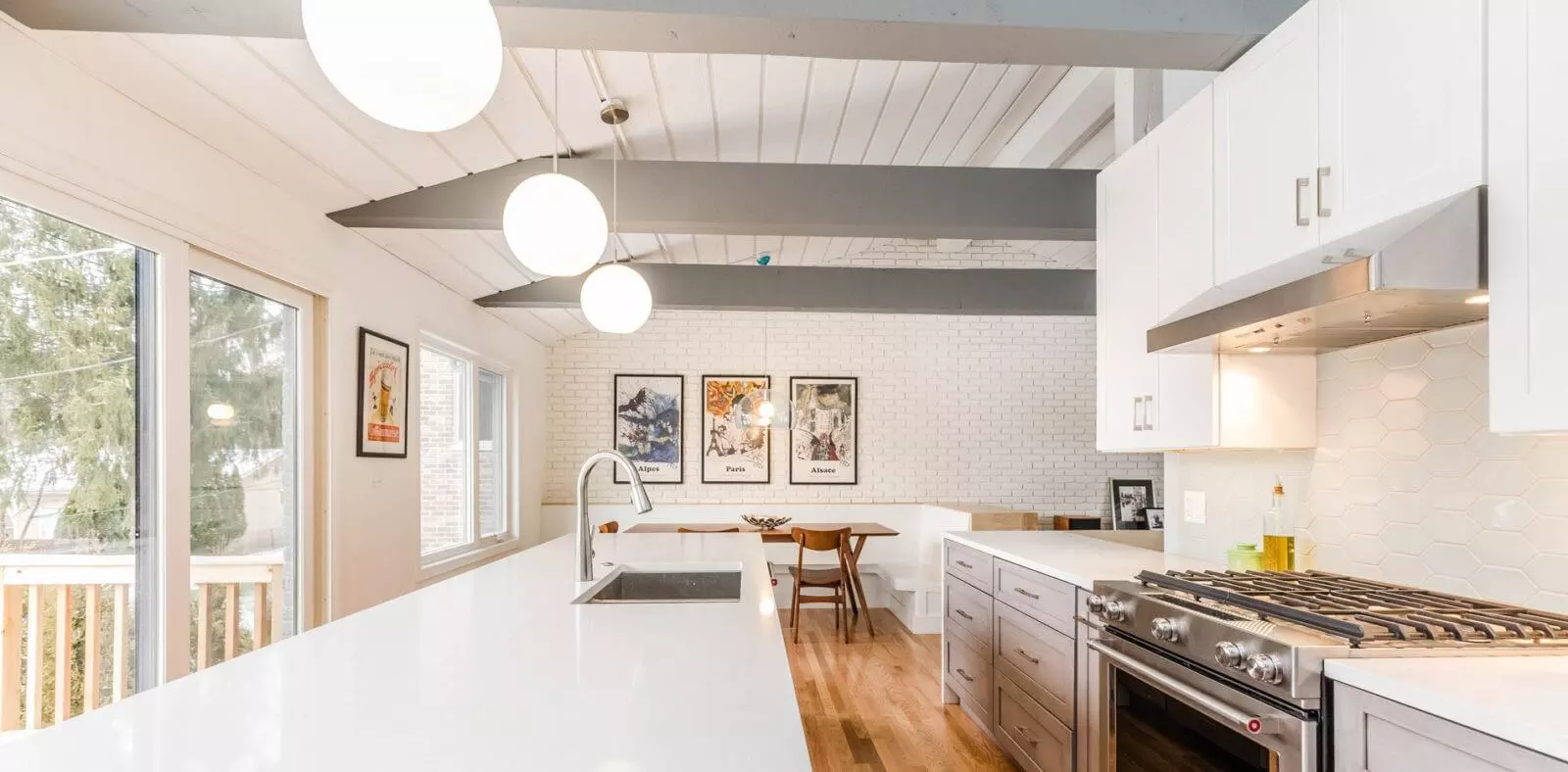 Modern kitchen renovation with white and wood accent theme and breakfast nook with built-in bench