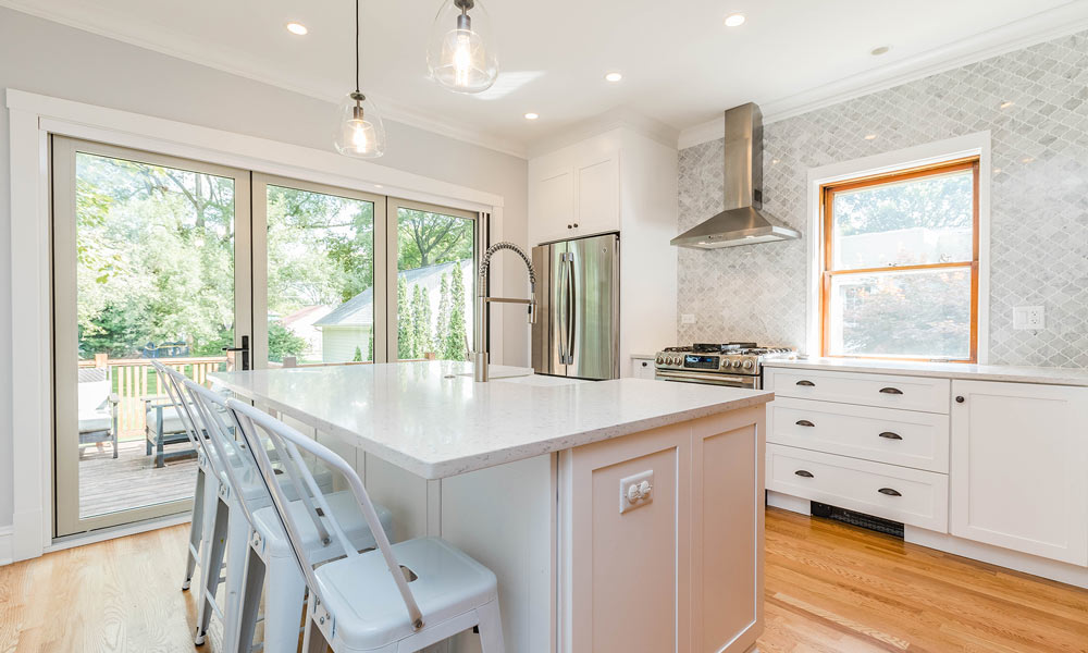 vintage bungalow kitchen remodel with golden pine window and folding door system