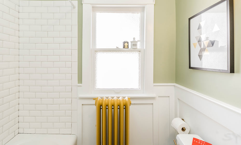 vintage bathroom remodel with green walls and god radiator