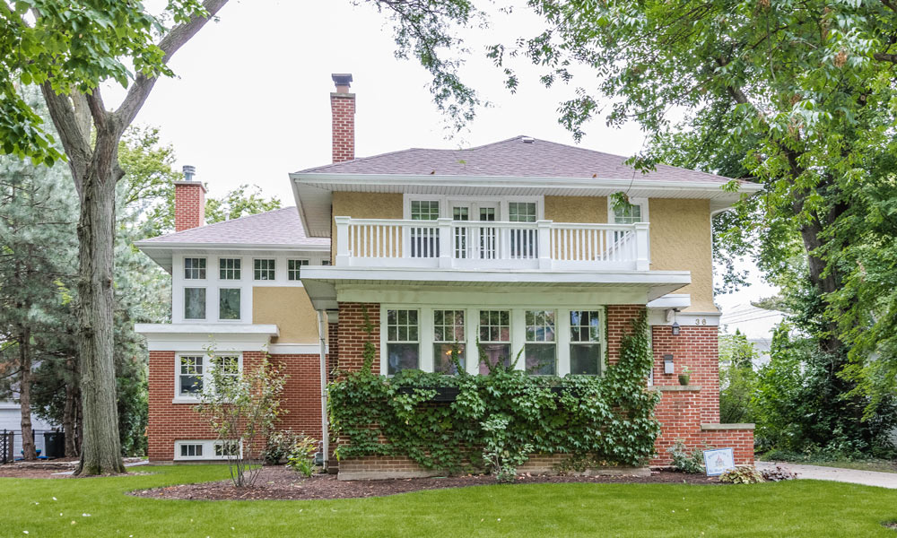 front view of a brick and stucco two-story addition