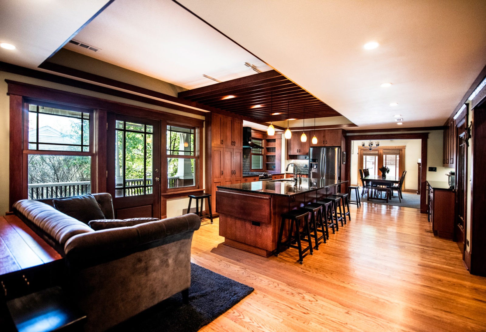 LivCo kitchen and living room renovation open concept dark wood island and hardwood flooring