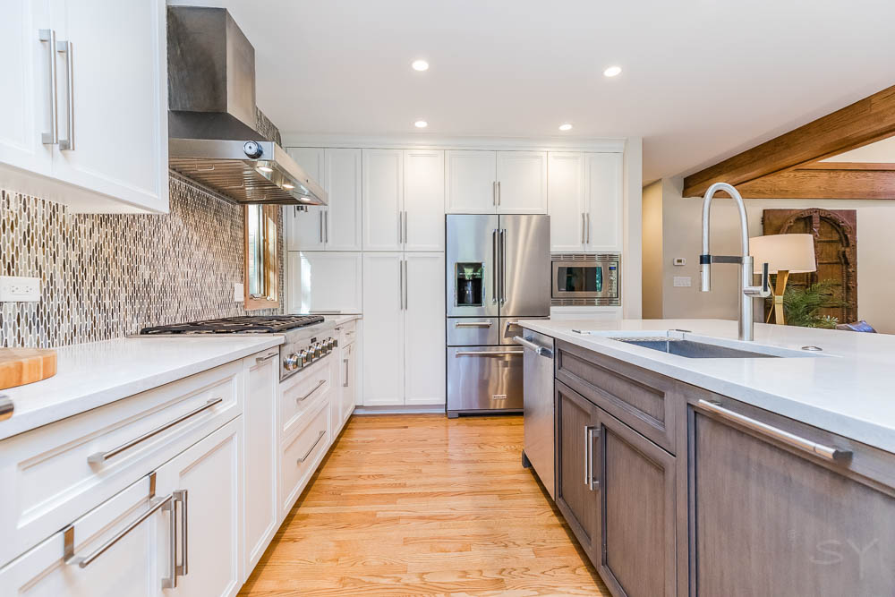 livco kitchen remodel hardwood floors white cabinets recess lighting geometric backsplash
