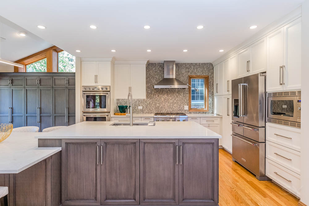 LivCo kitchen remodel with large double island and bar seating grey cabinets white overhead cabinets