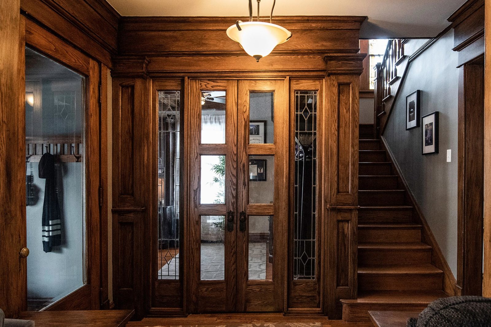 entryway renovation from livcompanies wood home office door staircase with photos on wall