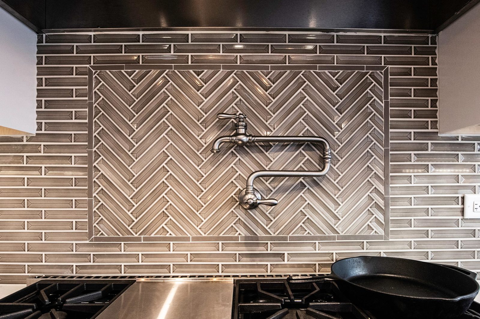 LivCo kitchen renovation tiled backsplash with over stove faucet stainless steel