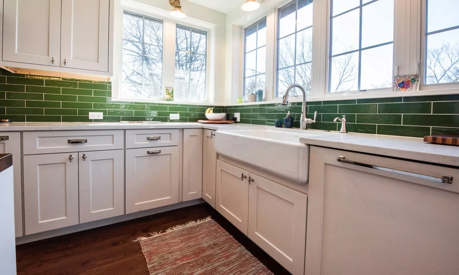 view of kithcen farmhouse sink with corner windows