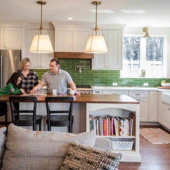 view of the family in the kitchen gathered at the island