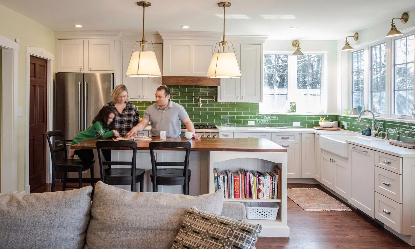 view of the family in the kitchen gathered at the island