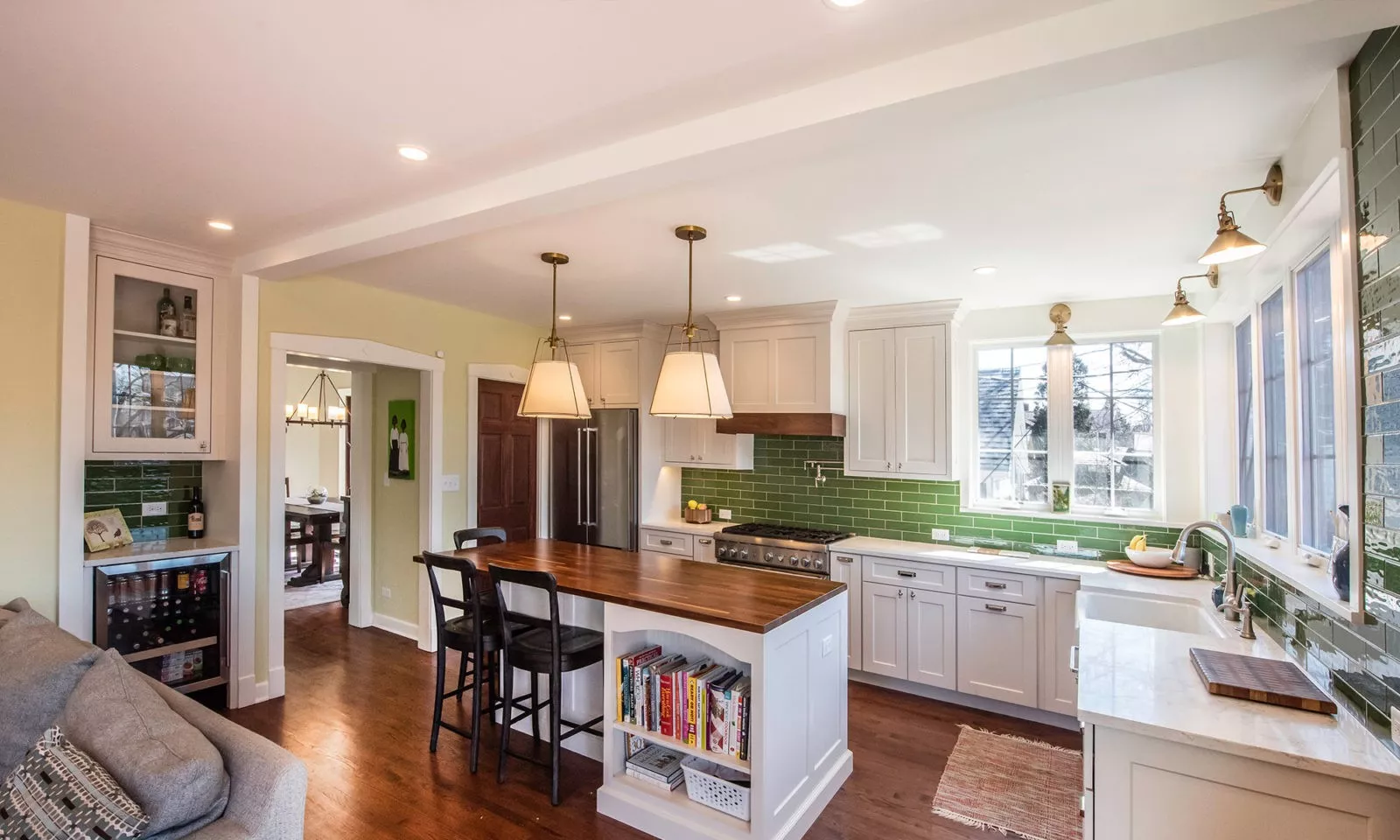 riverside kitchen with butcher block island and green backsplash tile