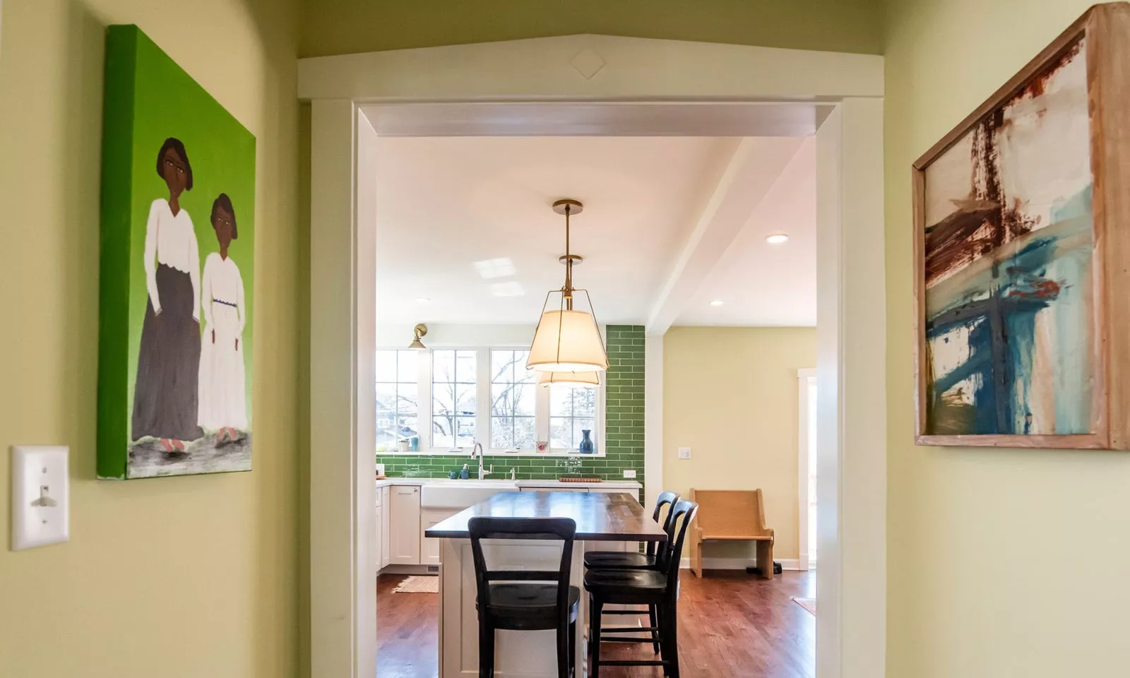 view of kitchen and windows over sink walking in from dining room