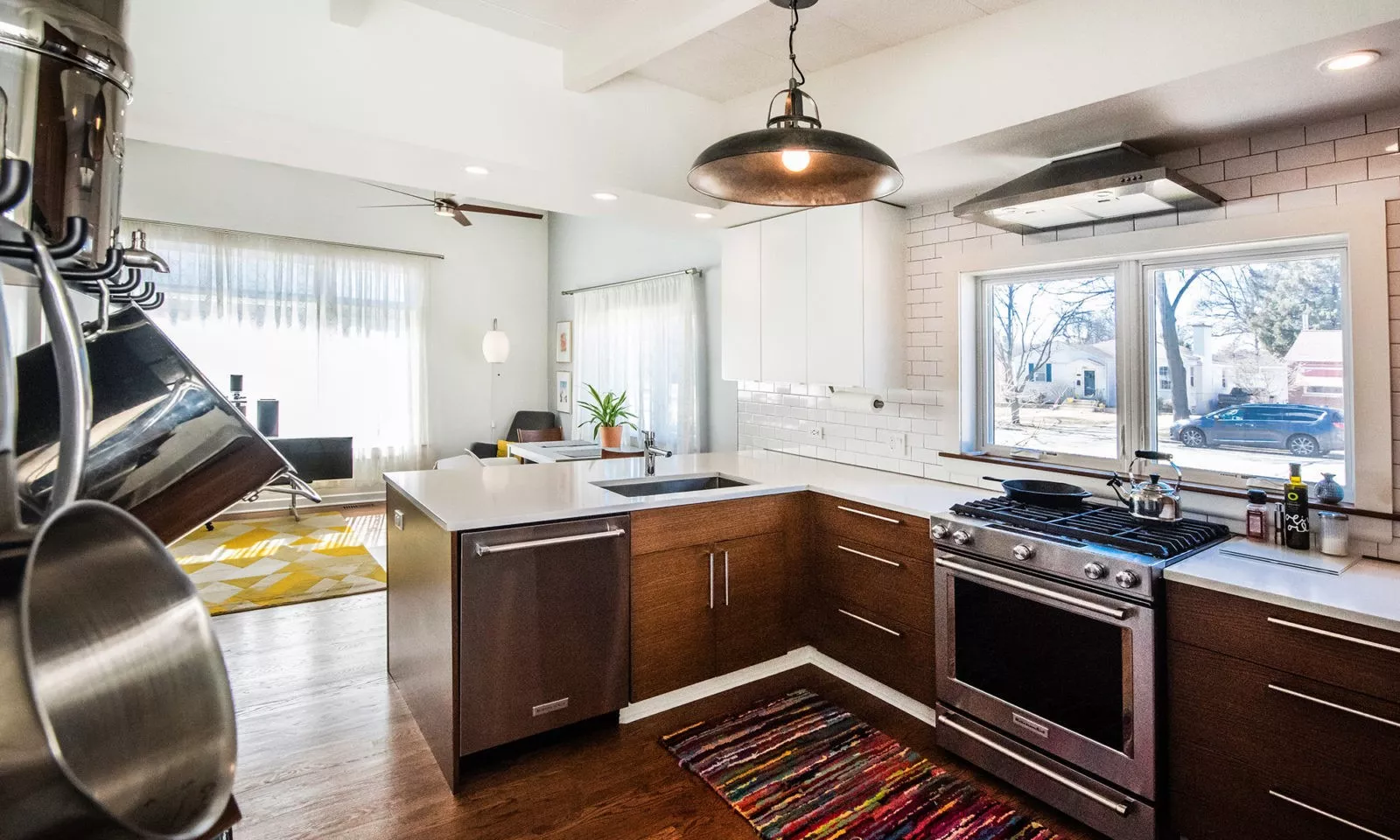 la grange kitchen with dark rift oak cabinets and cool light fixture