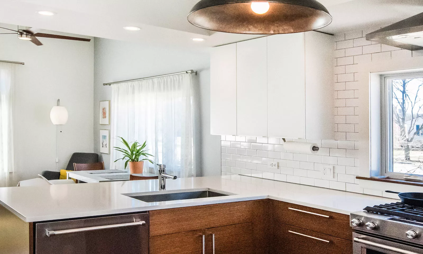 la grange kitchen with dark rift oak cabinets and white counters