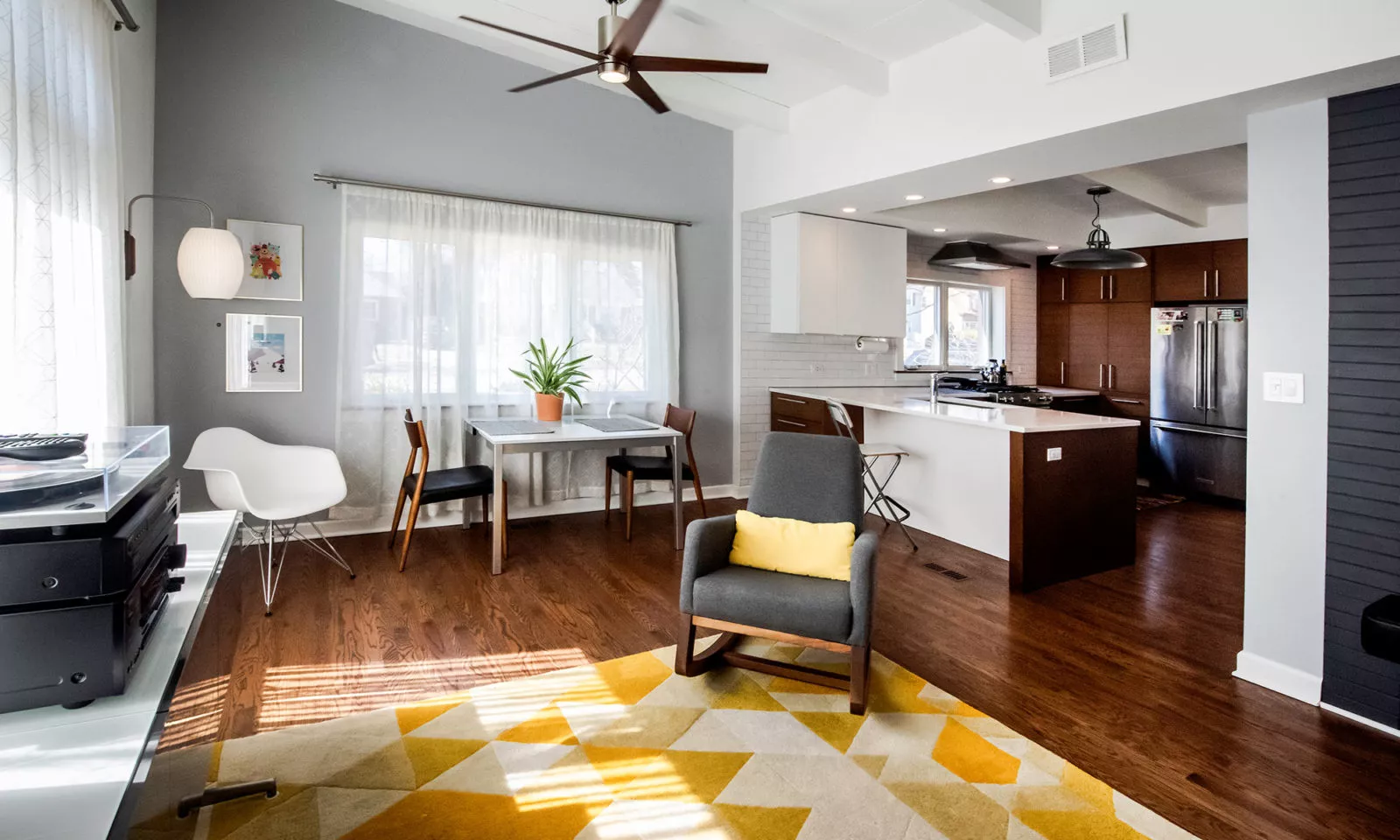 la grange kitchen with dark rift oak cabinets view from nthe fmaily room with peninsula