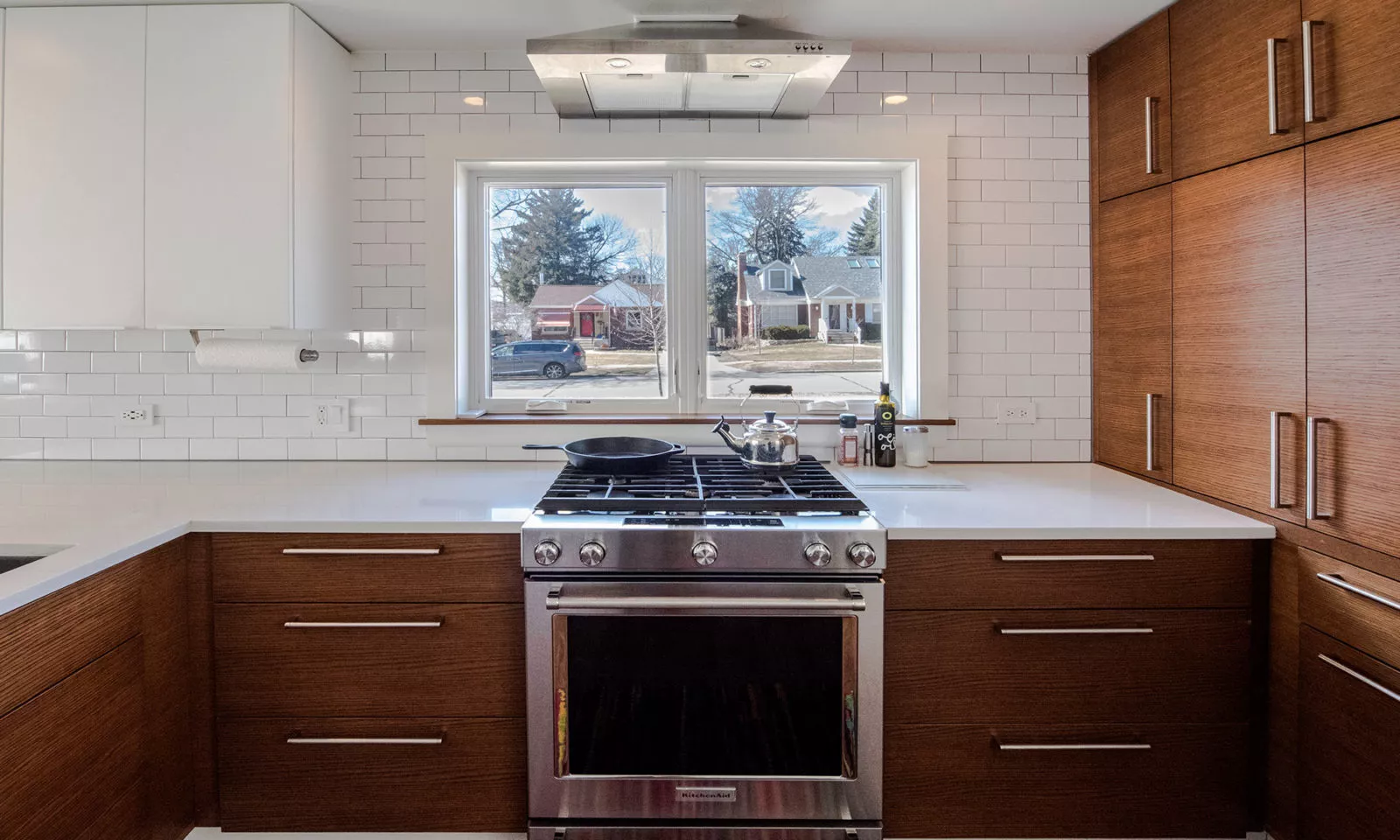 la grange kitchen with dark rift oak cabinets and cool light fixture