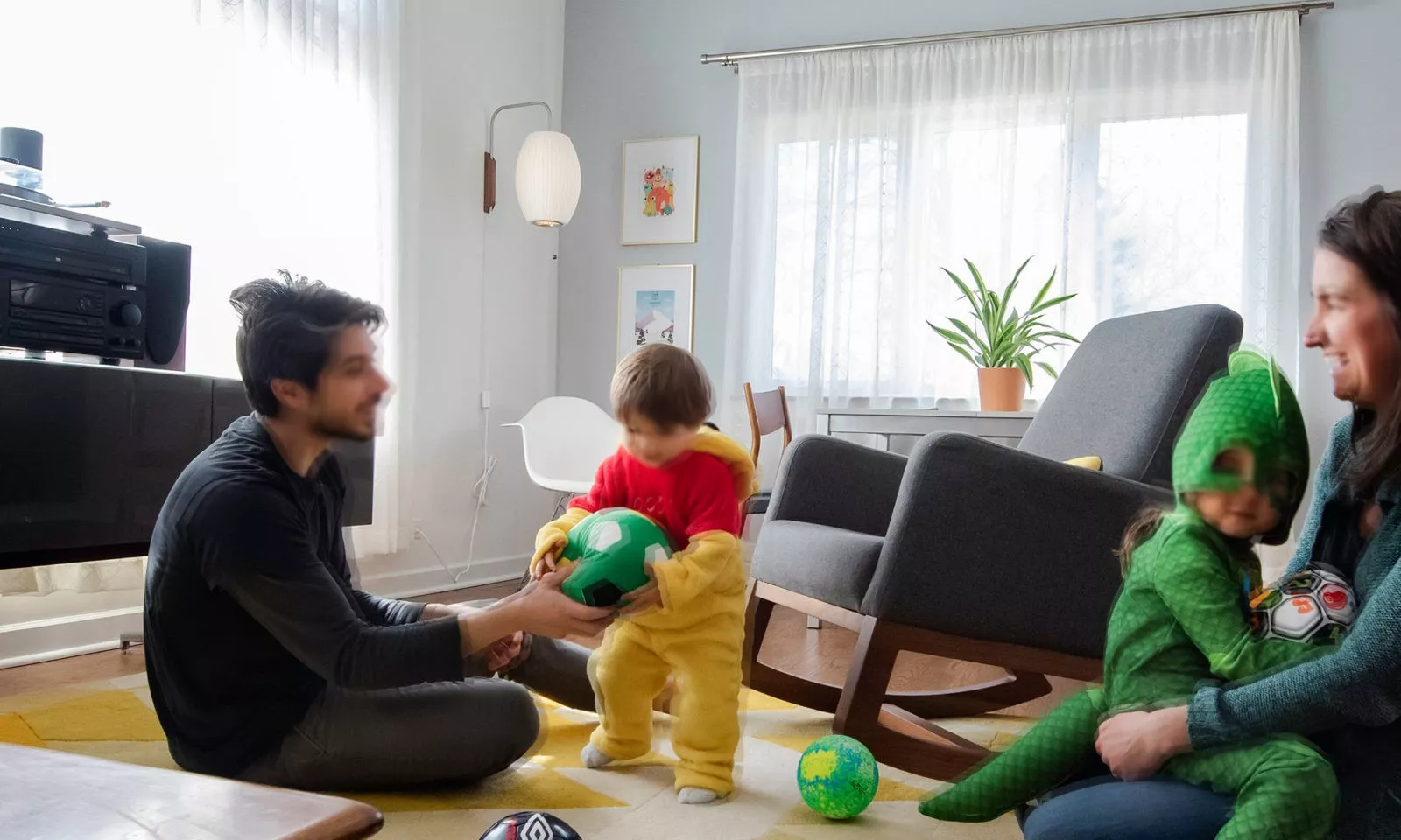 the family playing in the bright and open modern family room zoomed in