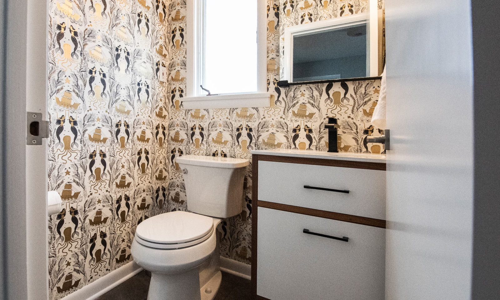 livco powder room remodel patterned wallpaper white and brown cabinets small window