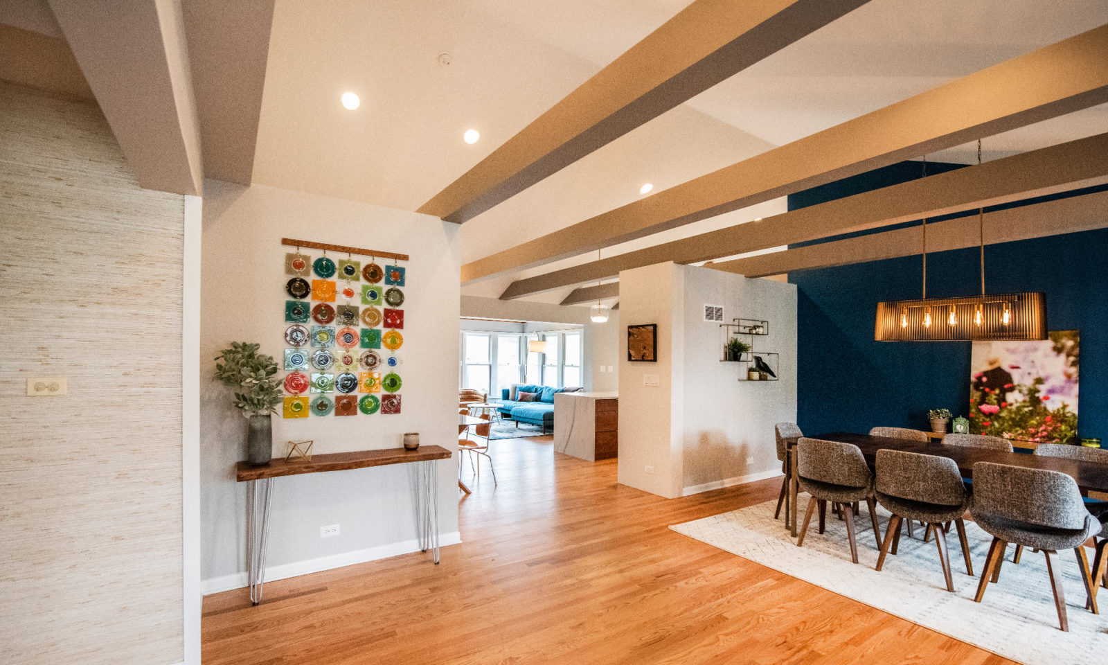 Dining room with table & chairs, connected to a small kitchen & living room