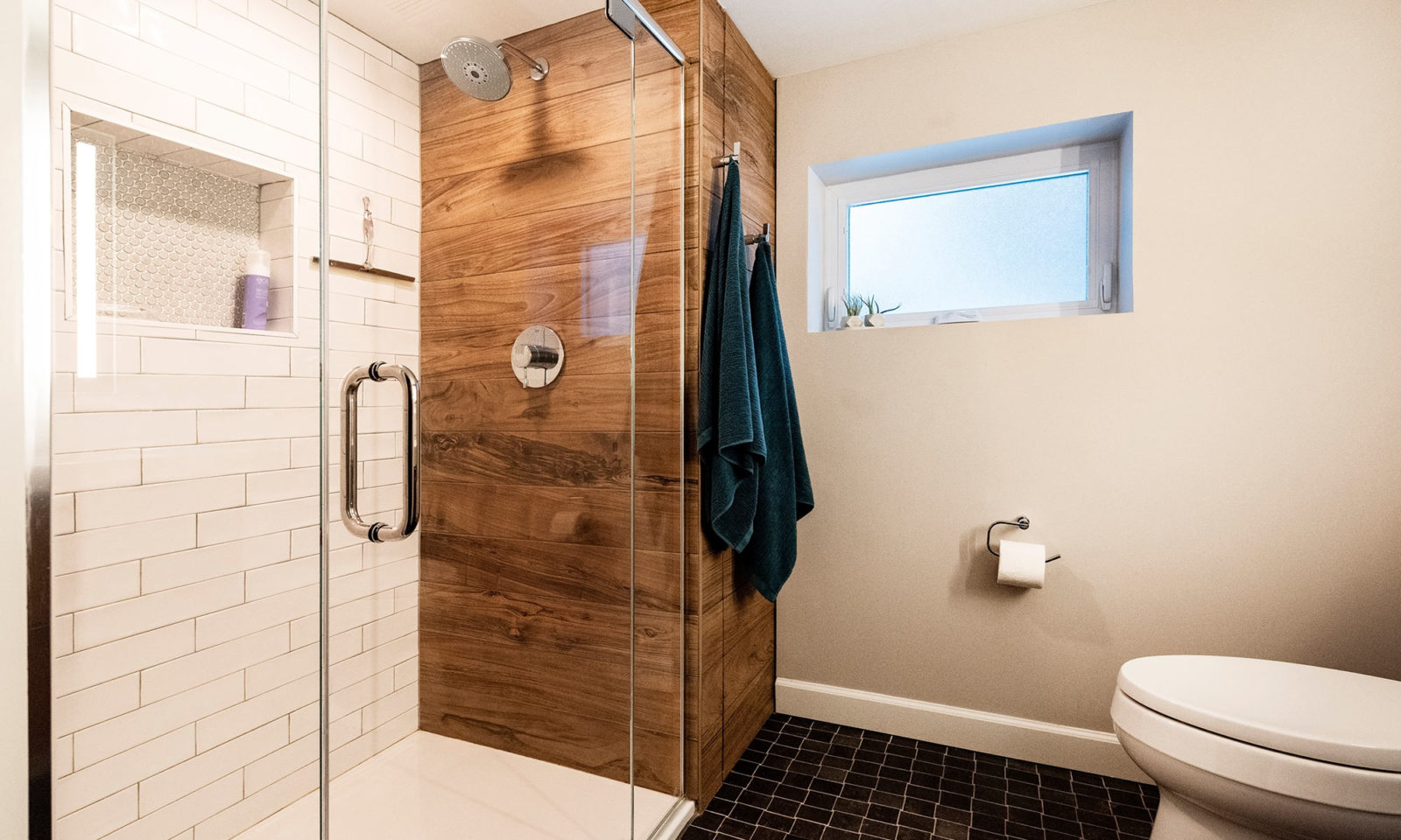 view of shower with white subway tile and wood looking tile