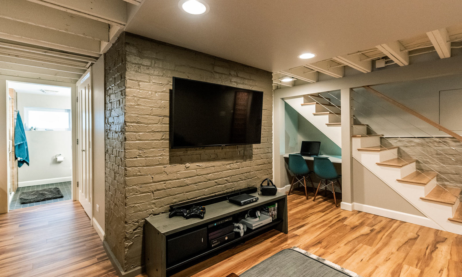 view of new basement rec room and wall mounted TV