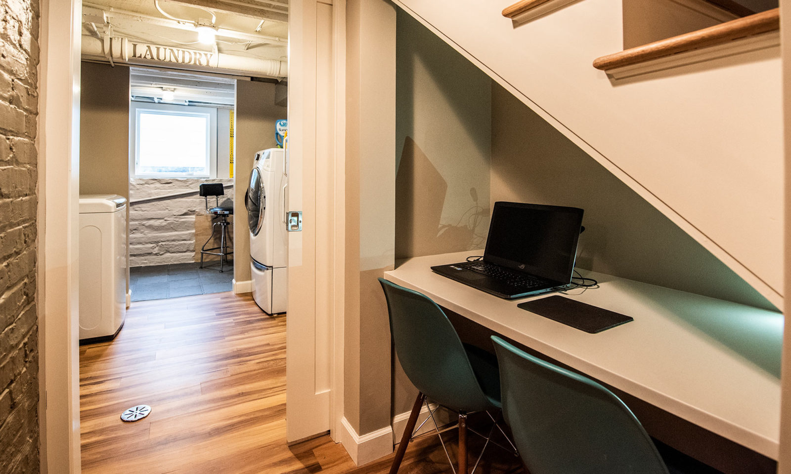 view of desk areas underneath basement stairs