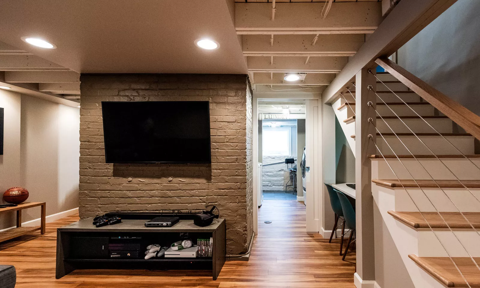 view of new basement rec room and wall mounted TV