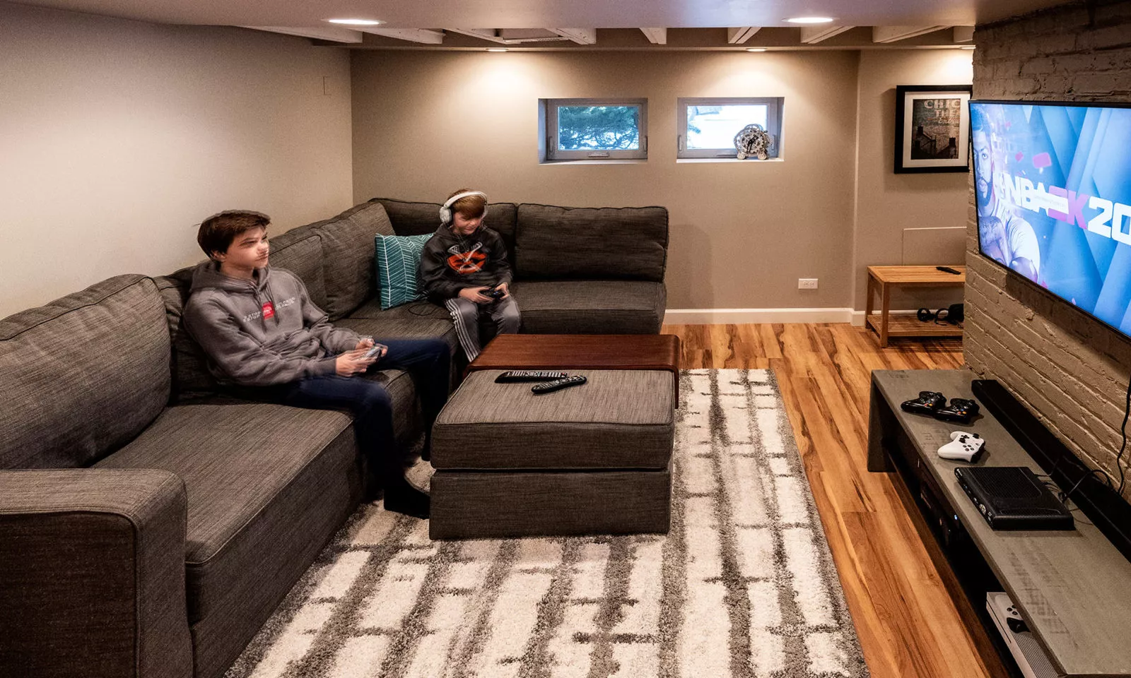 view of basement rec room with kids playing video games