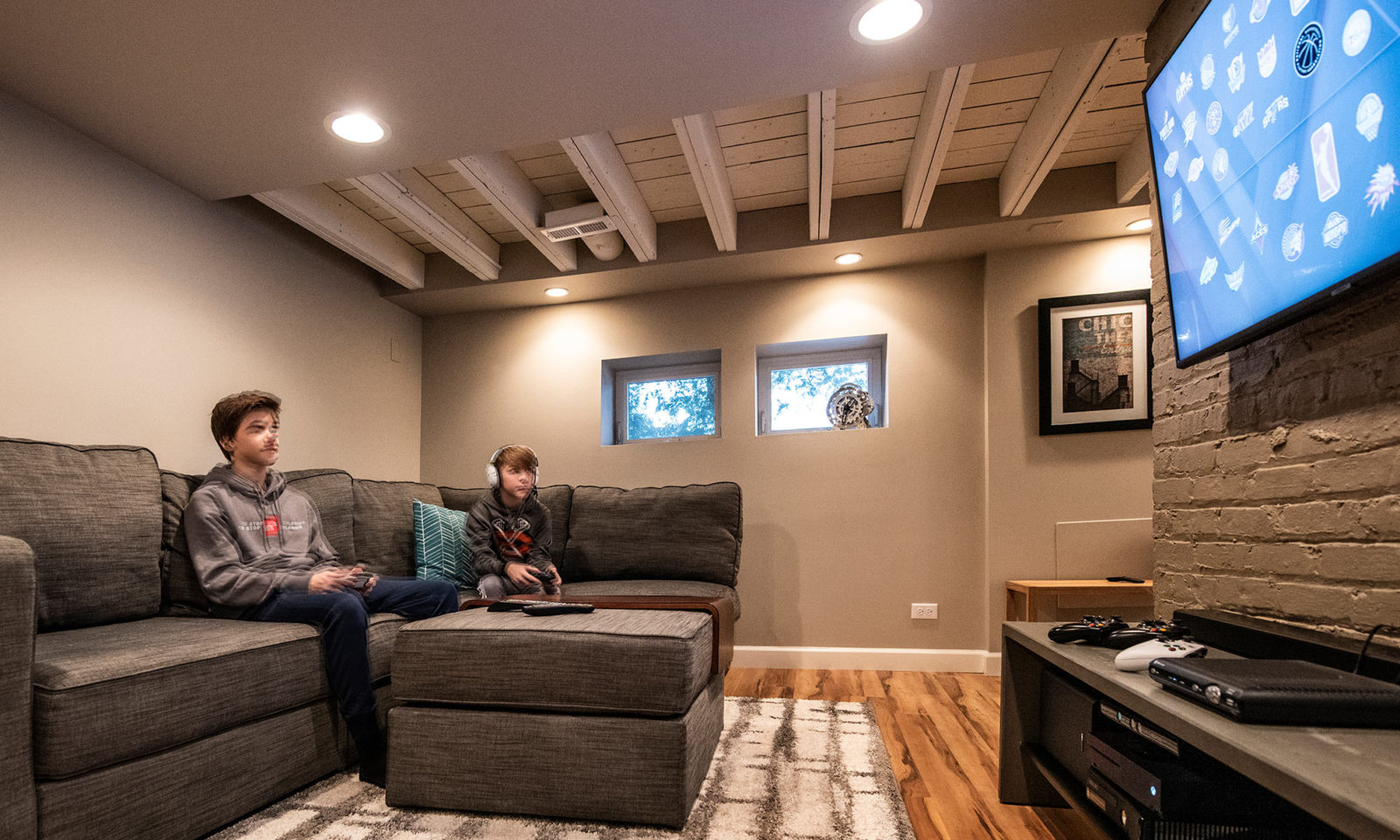 view of basement rec room with kids playing video games