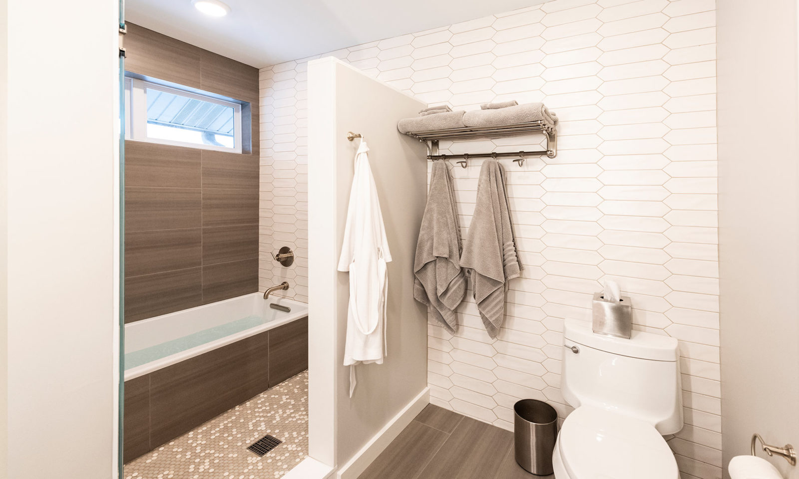 view into shower with hanging towels and robes