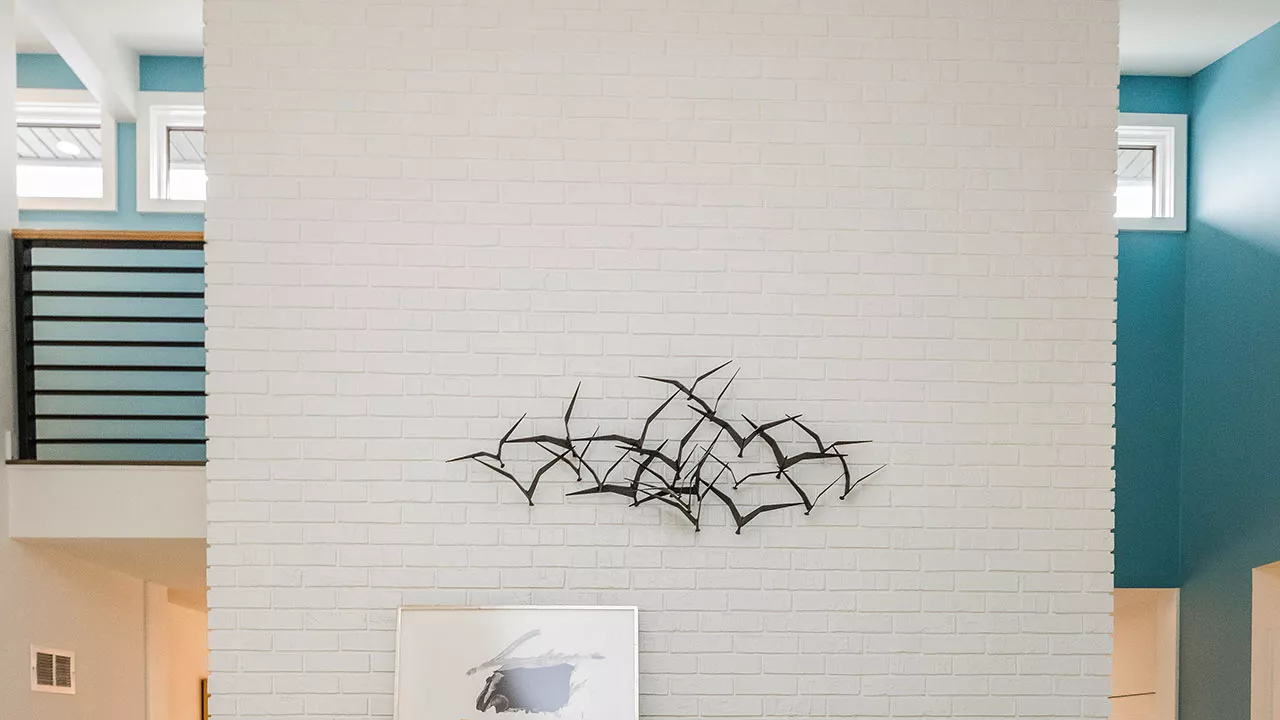 zoom background of a white brick chimney and bird sculpture