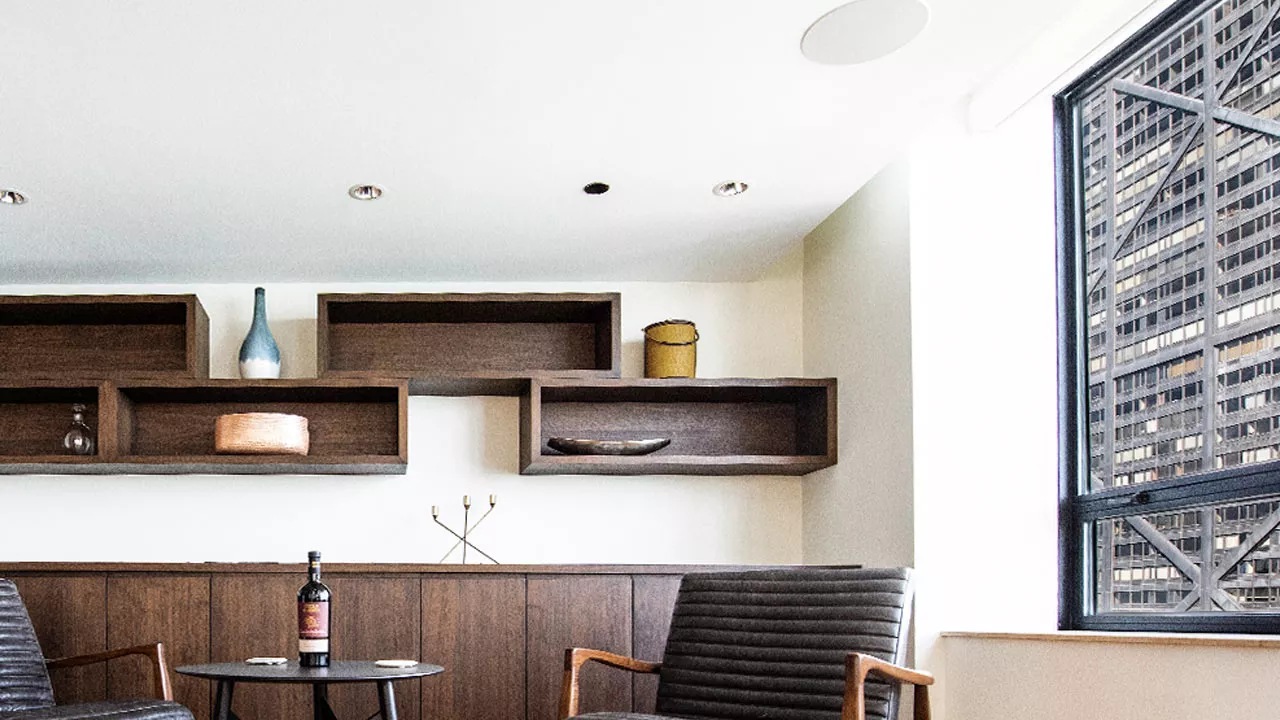 zoom background of a modern highrise built-in cabinetry and bottle of wine