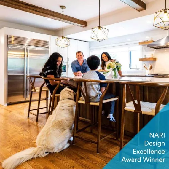 family and dog gathering around the island of their recently remodeled luxury kitchen