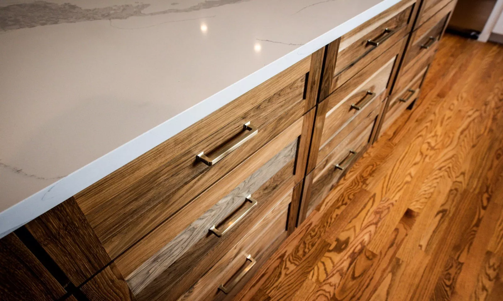 Statement wooden kitchen island with gold sleek drawer pulls