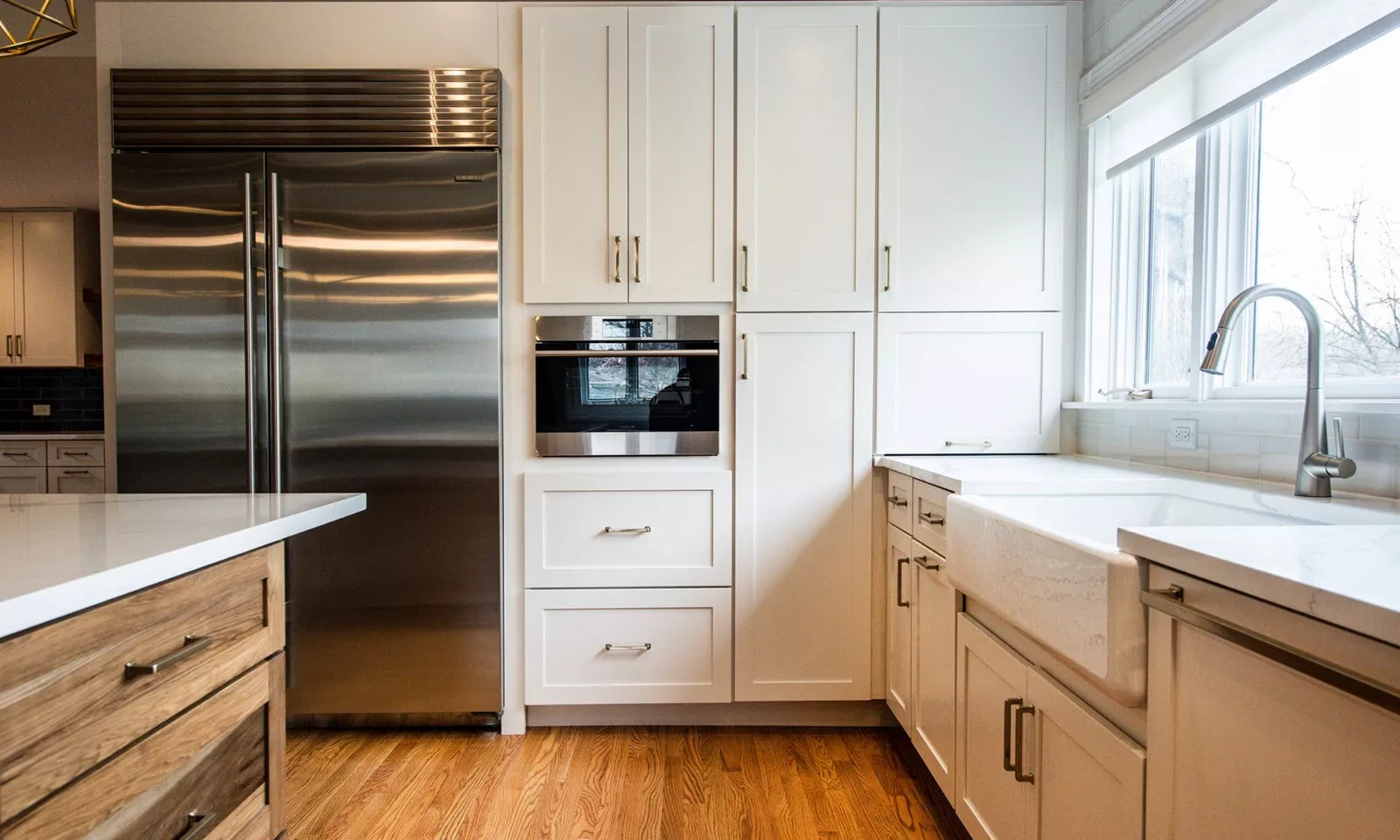 cream cabinets with sleek handles and stainless steel appliances in a kitchen