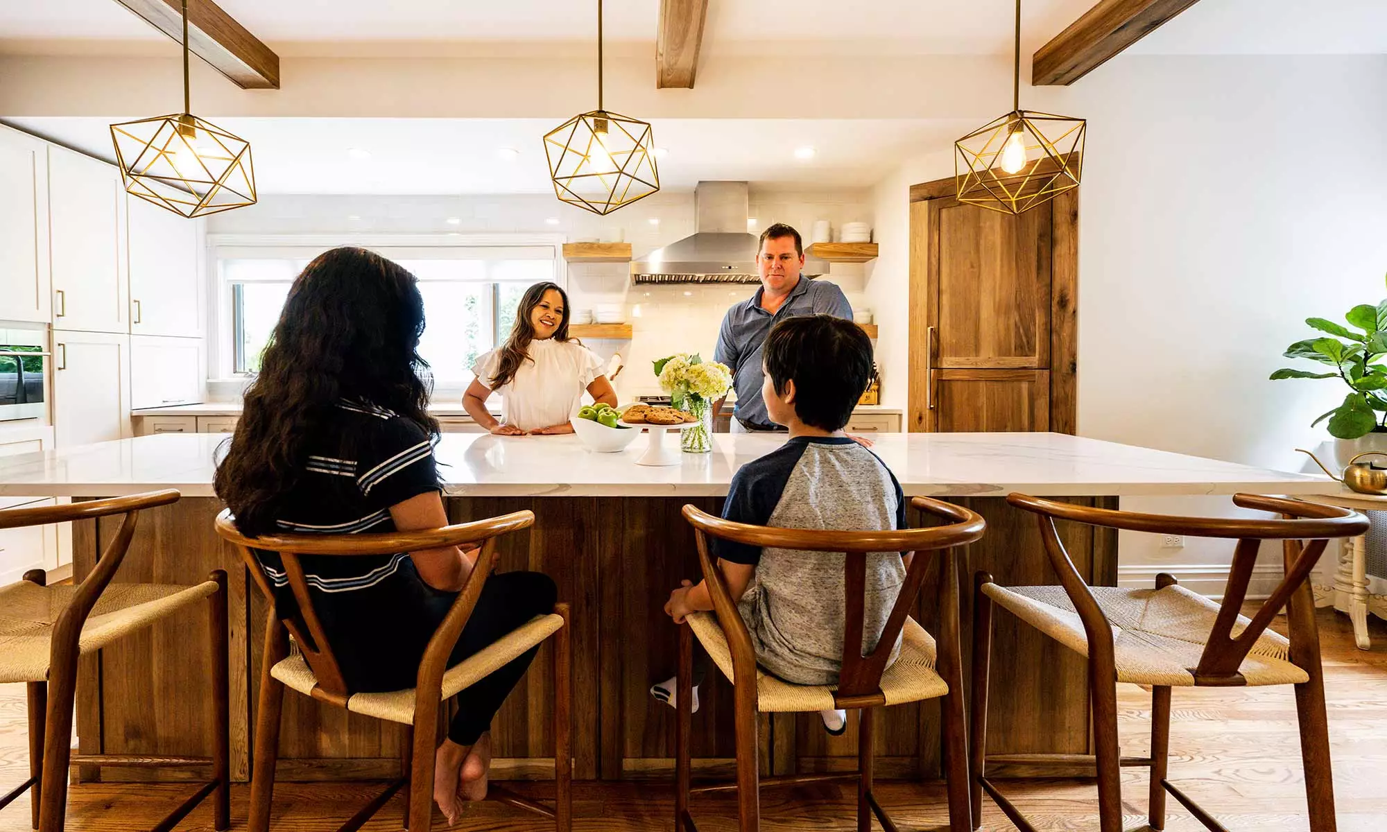 family around luxury kitchen island with dog