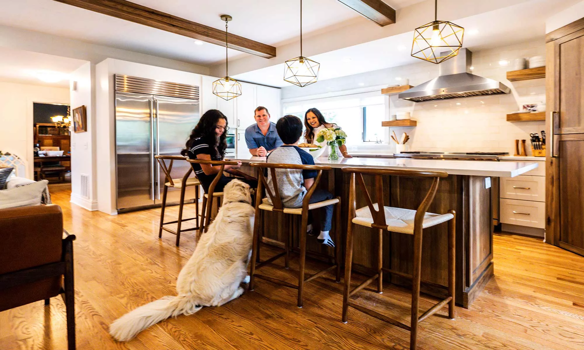 family around luxury kitchen island with dog