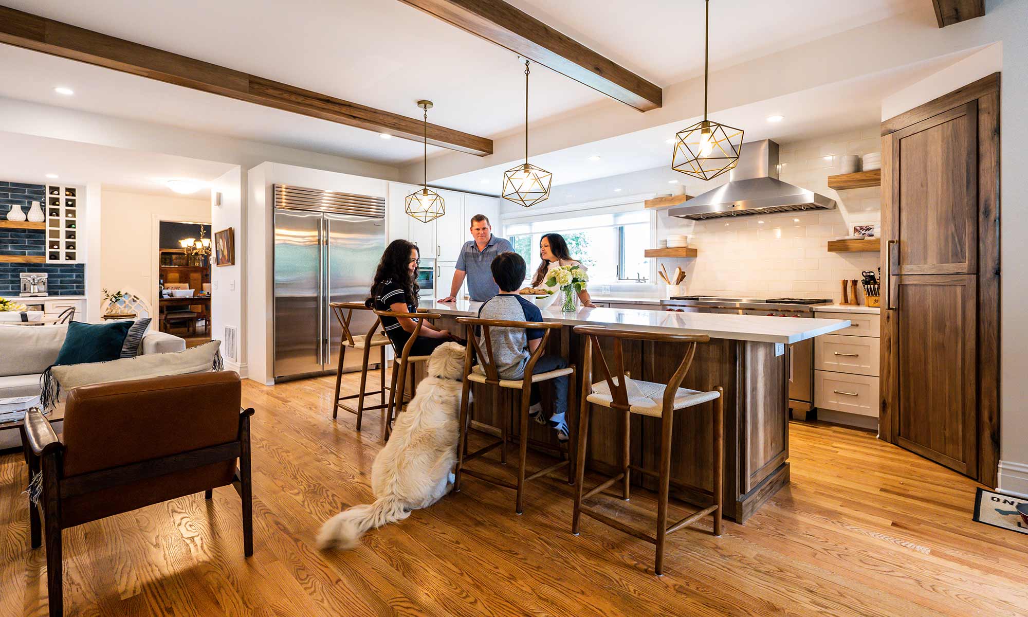 family around luxury kitchen island with dog