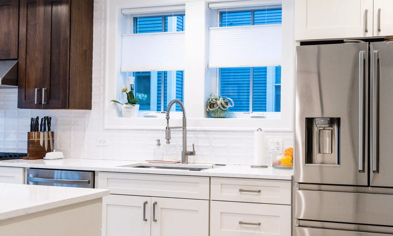 Newly renovated kitchen with white cabinetry and stainless steel appliances